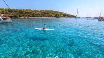 Crystal clear sea and stand up pedal at the beach of Budikovac island