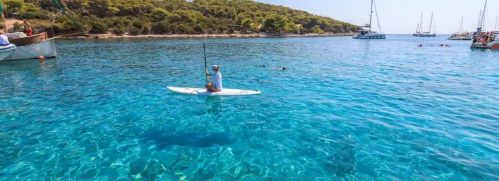 Crystal clear sea and stand up pedal at the beach of Budikovac island