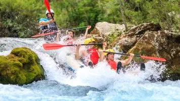 Sliding down a rapid on Cetina rapid rafting day tour