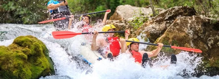 Sliding down a rapid on Cetina rapid rafting day tour